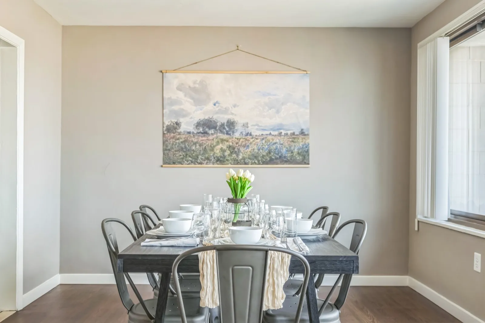 Dining table set for an elegant meal with track lighting in an Arlington VA corporate rental