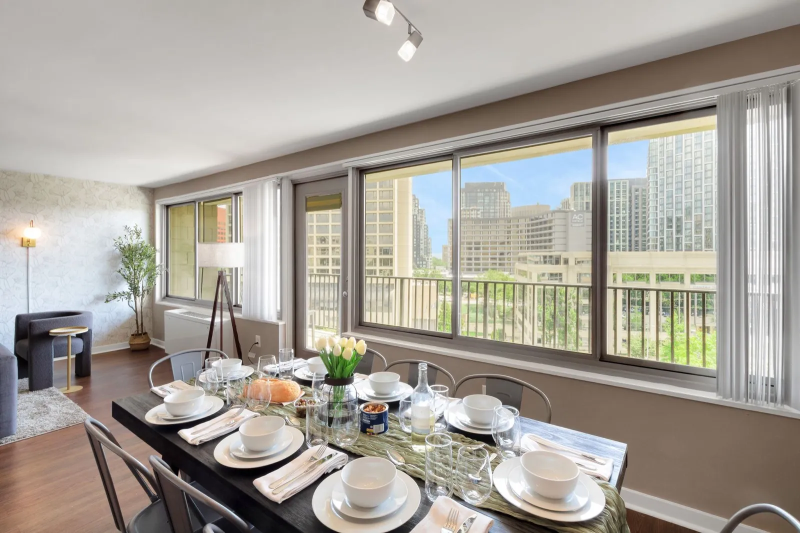 Eight-seat dining table beside wide windows with daytime city views, Arlington VA furnished apartment