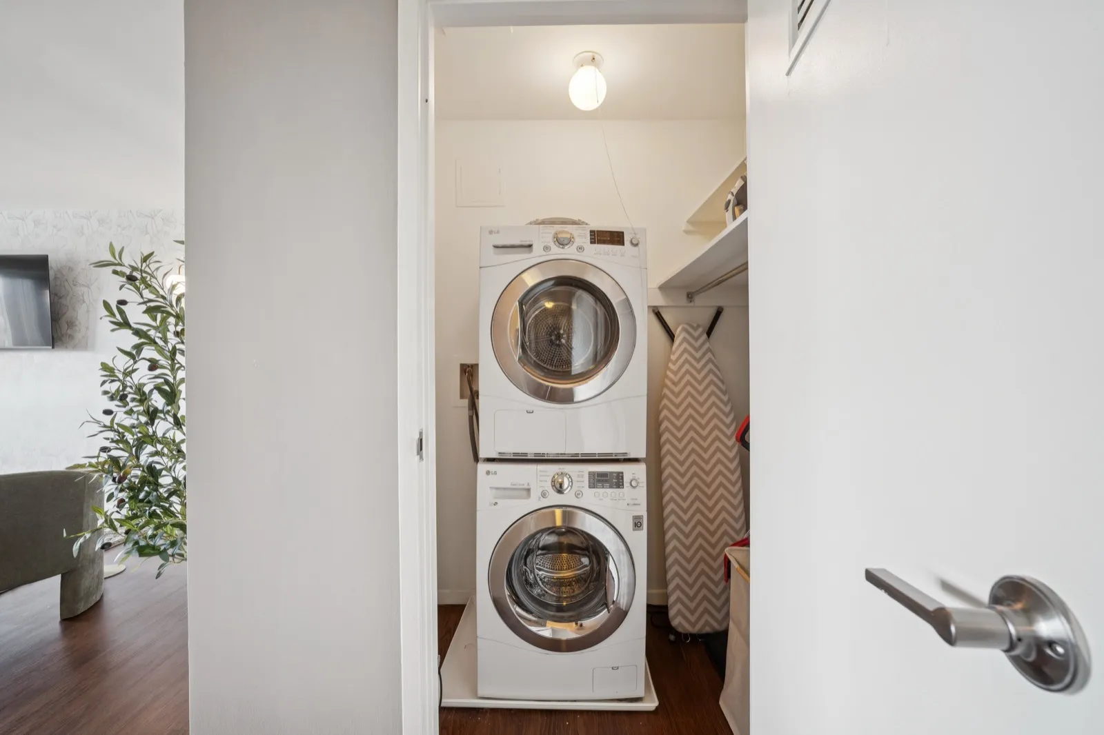 In-unit stacked LG front-load washer and dryer with ironing board in a Crystal City furnished apartment