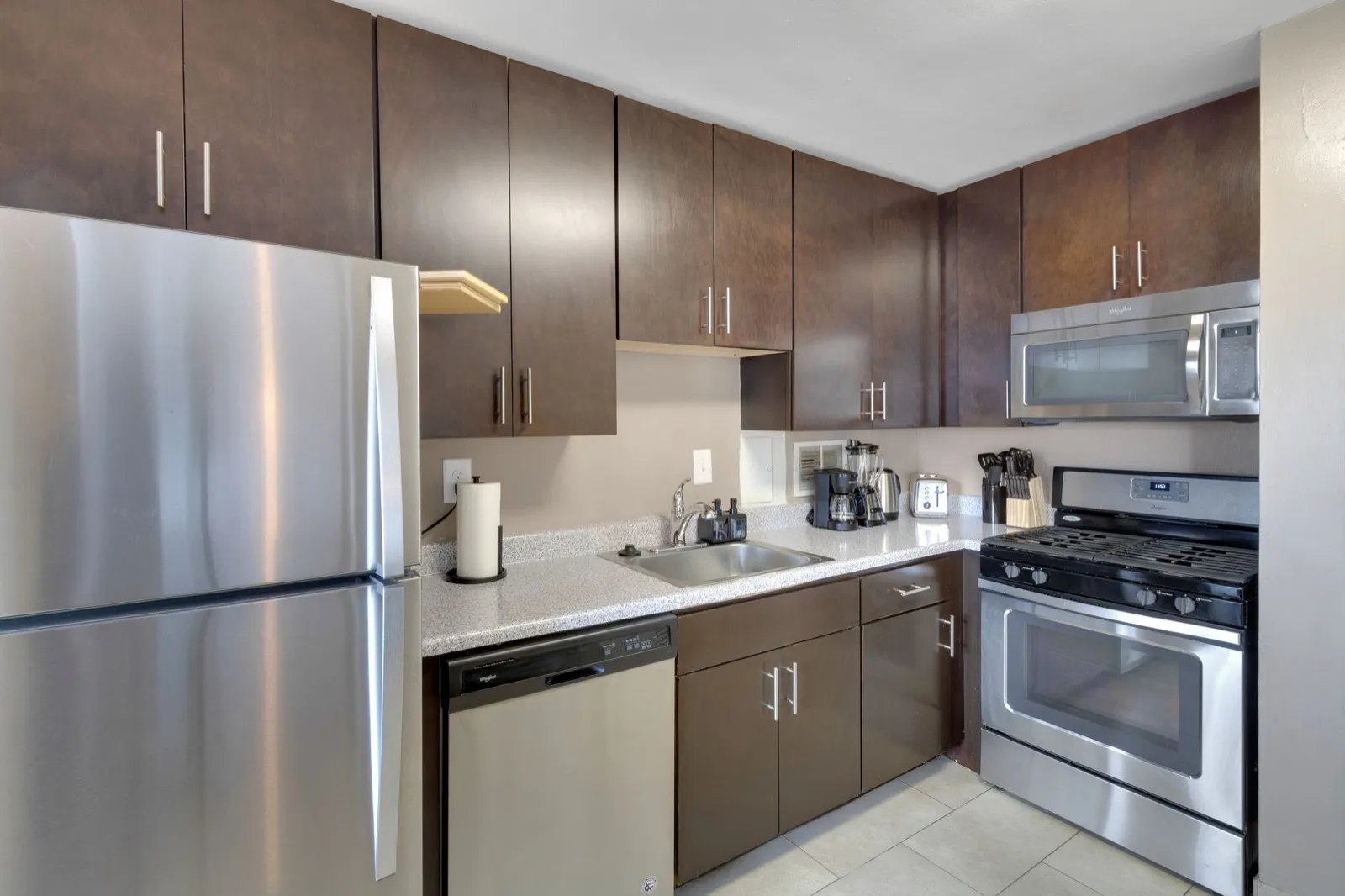 Full-size kitchen with dishwasher, refrigerator, and generous counter space in a Crystal City furnished apartment