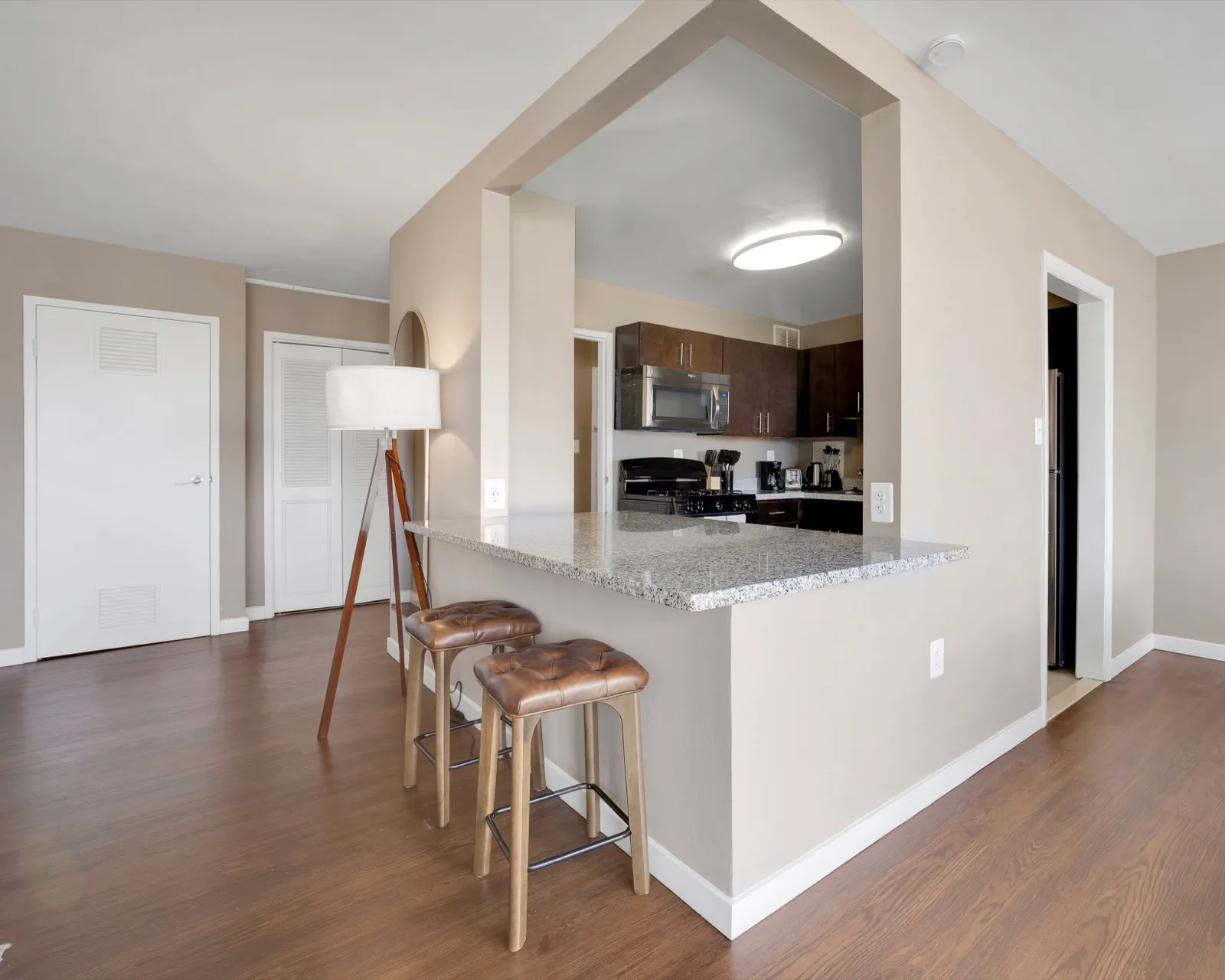 Kitchen with a gas range, stainless steel hood, and modern cabinetry in an Arlington VA furnished apartment