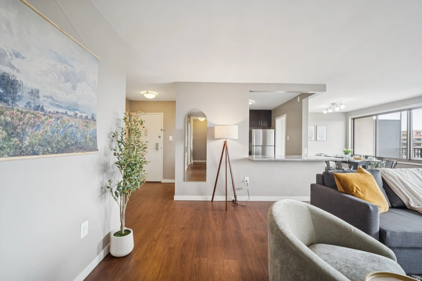 Living room with an accent wallpaper wall, modern furnishings, and natural light in Crystal City