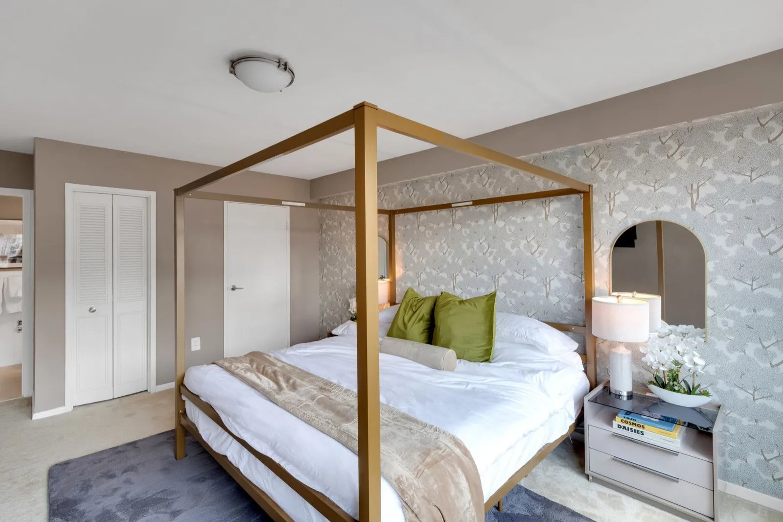 Primary suite with a four-poster bed, designer nightstand, and a tripod reading lamp, Arlington VA