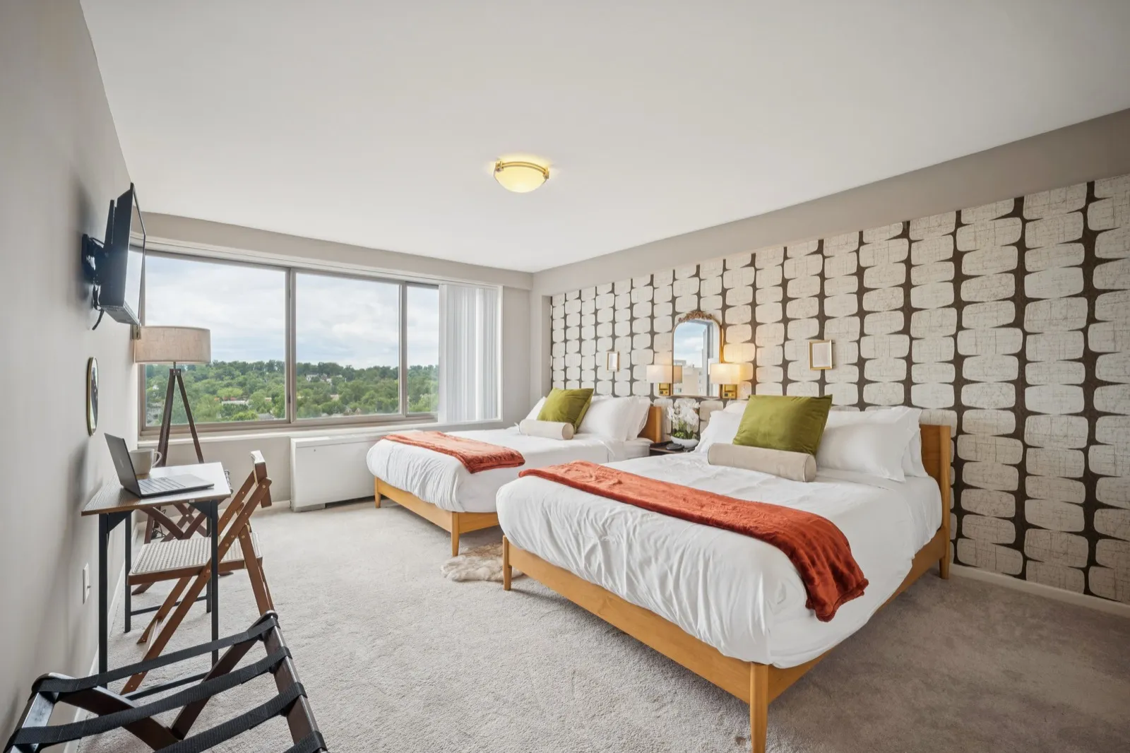 Spacious second bedroom with two beds, a designer accent wall, and panoramic views in Crystal City